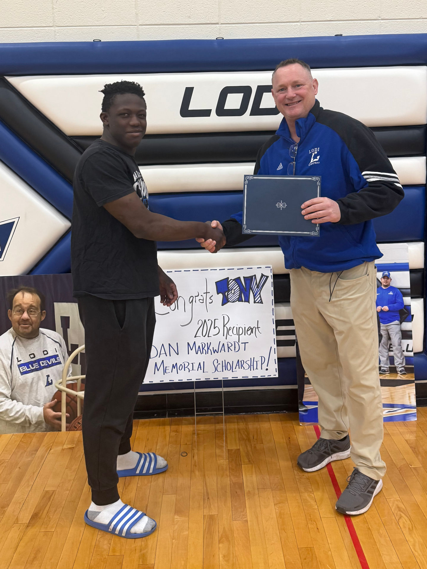 DMMF Board President, Mitch Hauser, presenting a 2025 scholarship to Tony